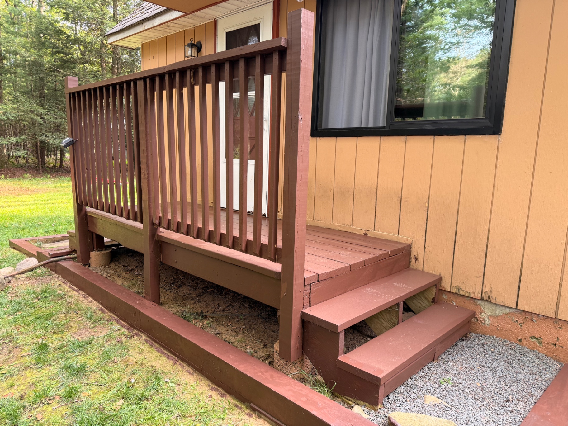 Finished brown railing, deck, and stairs